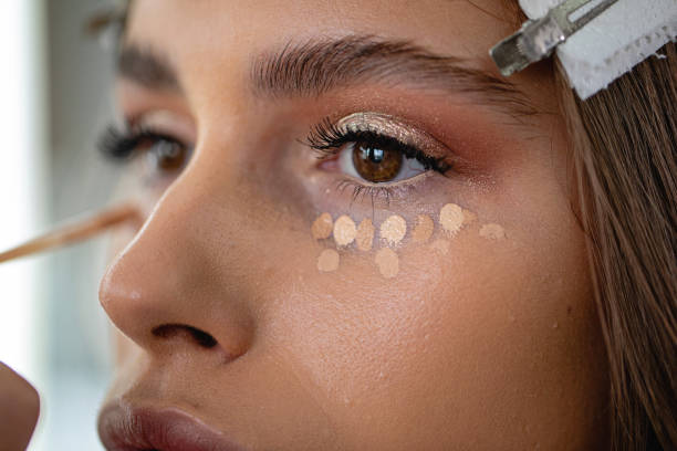 Skin care business Professional model in a beauty salon enjoying getting makeup on concealer stock pictures, royalty-free photos & images