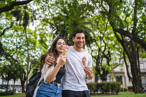 Couple eating ice cream while on a walk outdoors