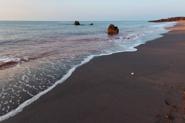 The image is taken in beautiful Hormuz Island, an Iranian island in Persian Gulf, Hormozgan Province. Hormuz Island is a dome-shaped salty island located in the Strait of Hormuz. The island is arid, covered by sedimentary rock and layers of volcanic material, and the mountains are beautifully colourful.