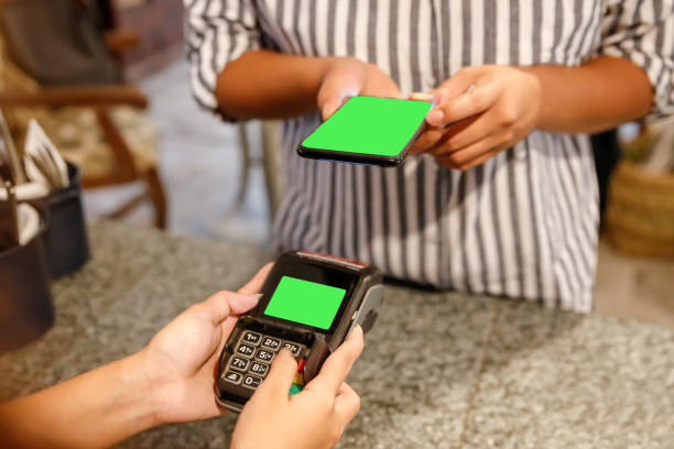 istock Female entrepreneur using smartphone to make cashless payment 1206731179