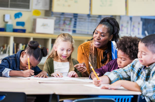 istock African-American elementary school teacher with class 1206735259
