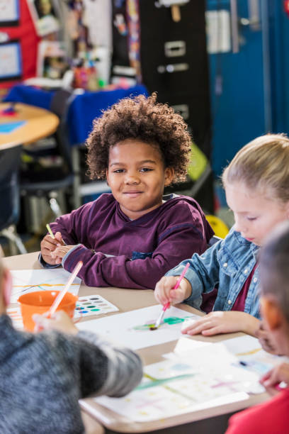 istock African-American boy with classmates in art class 1206736246