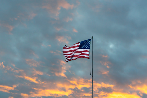 American flag against a dark and cloudy background
