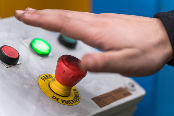 istock Hand pressing the red emergency button or stop button for industrial machine, Emergency Stop for Safety. 1206737317
