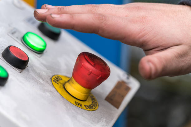 istock Hand pressing the red emergency button or stop button for industrial machine, Emergency Stop for Safety. 1206737331
