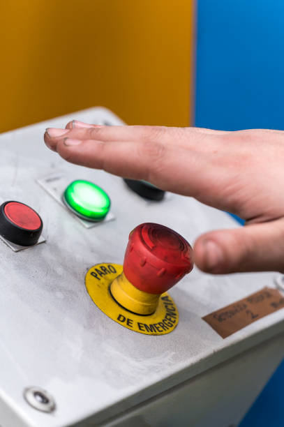 istock Hand pressing the red emergency button or stop button for industrial machine, Emergency Stop for Safety. 1206737340