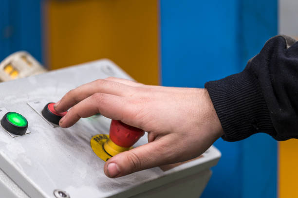 istock Hand pressing the red emergency button or stop button for industrial machine, Emergency Stop for Safety. 1206737351