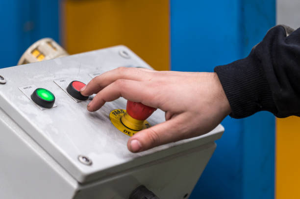 istock Hand pressing the red emergency button or stop button for industrial machine, Emergency Stop for Safety. 1206737360