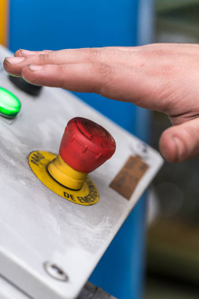 istock Hand pressing the red emergency button or stop button for industrial machine, Emergency Stop for Safety. 1206737379