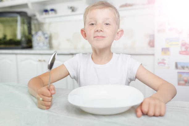 istock the child has breakfast at the table 1206738132