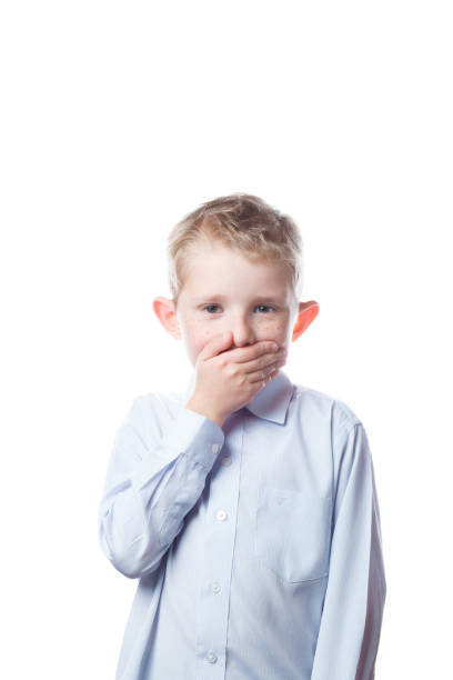 istock boy is scared and closing his mouth 1206738815