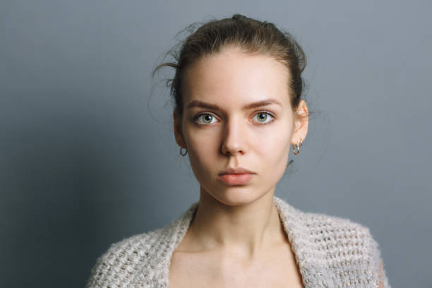 istock portrait beautiful young girl on gray background 1206738896