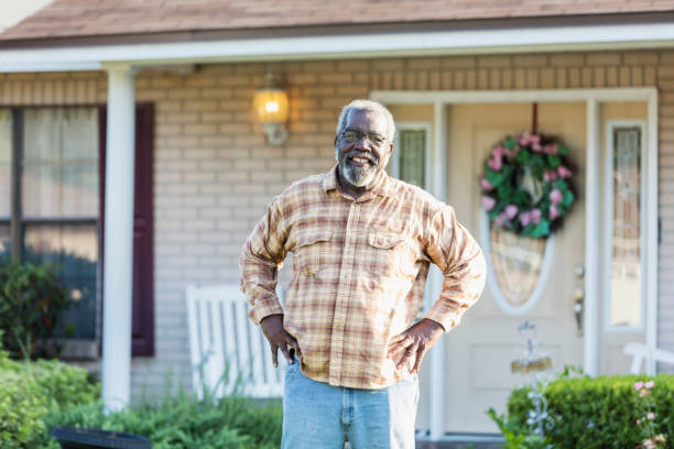 istock Senior man standing in front of home 1206739950