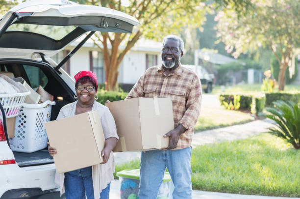 istock Senior African-American couple moving, unloading boxes 1206740050
