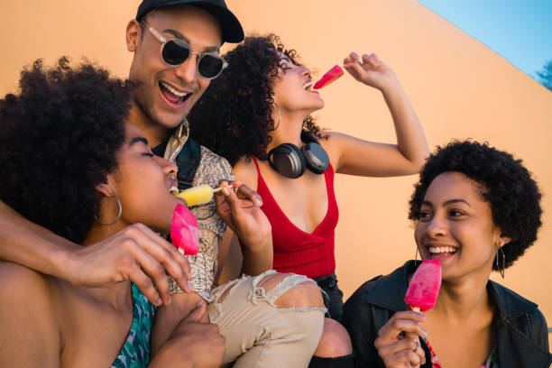 istock Multi-ethnic group of friends enjoying summertime while eating ice cream. 1206740112