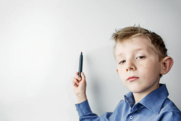 istock child on the blackboard with a marker in his hand 1206740767