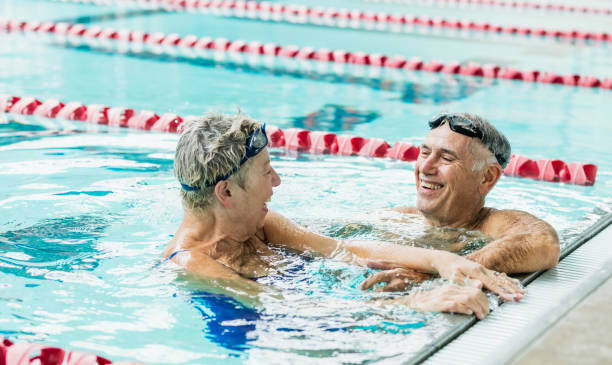 istock Senior couple exercising together, swimming laps 1206741058