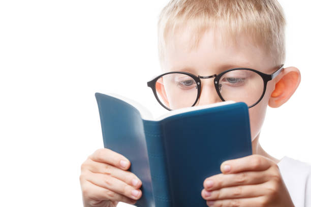 istock little boy with glasses reading a book 1206741864