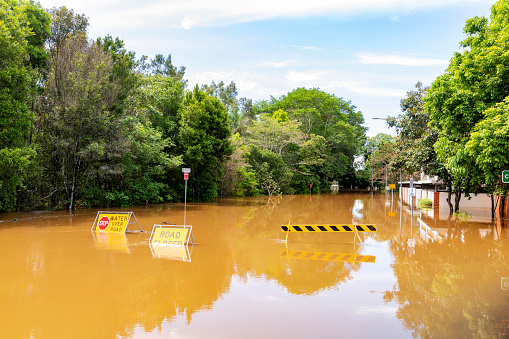 Flood sign on a road under water near the Lismore, NSW, central business district