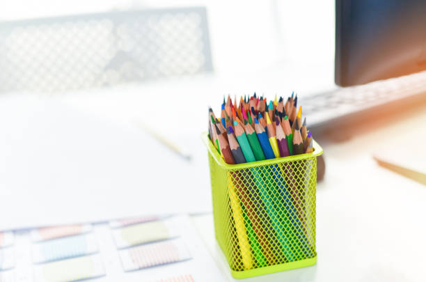 istock Desk in office with computer and Color pencils or Crayons colored for designer desk - Table working place business office background 1206744933