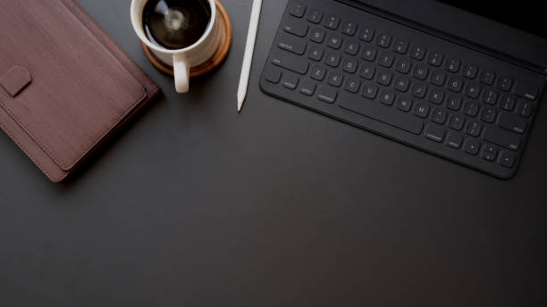 istock Overhead shot of dark modern workplace with copy space on black table background 1206748674