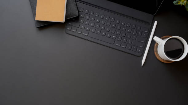 istock Top view of dark modern workplace with copy space on black table background 1206748711