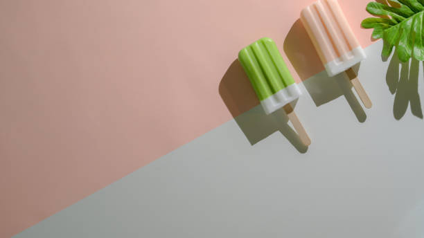 Overhead shot of minimal summer concept with popsicles on flat lay red and blue background
