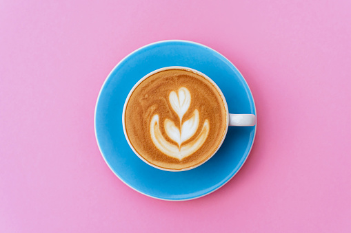 Coffee cup on pink background isolated copy space