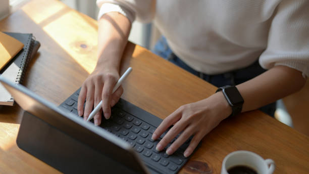 istock Cropped shot of girl working on her project while typing on tablet 1206749925