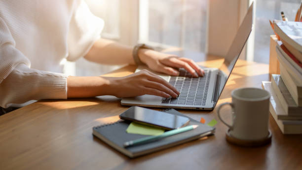 istock Close-up view of student taking notes on her exam in comfortable working space 1206750022