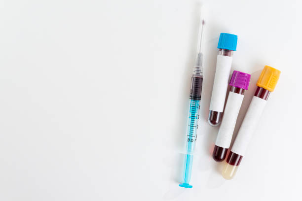 istock Test tubes with blood isolated and syringe on white 1206750871