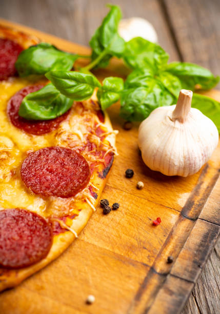 istock Fresh pepperoni pizza served on the wooden board 1206752060