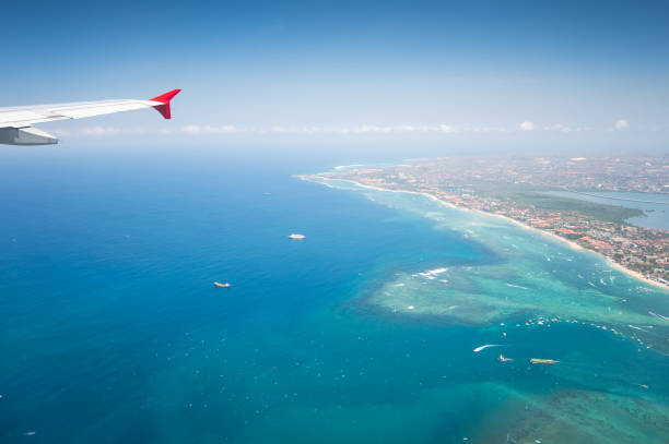 istock Wing of an airplane flying above the clouds with blue sky. 1206752806