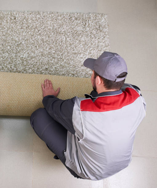 istock Male Worker Unrolling Carpet On Floor At Home, view from above 1206756244