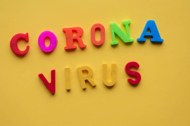 istock Corona virus spelled out against bright yellow background 1206756607