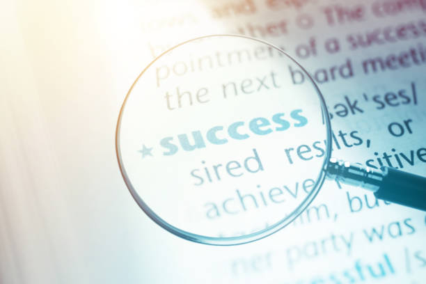 istock Success Word in Dictionary Through Magnifying Glass 1206761483