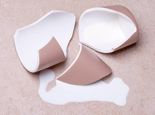 istock Broken cup and spilled milk on the floor 120676507