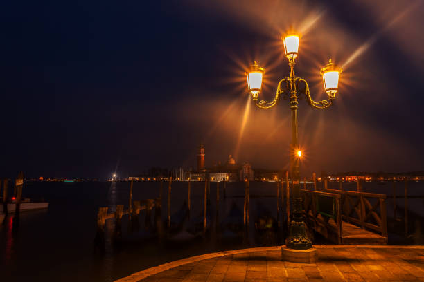 Early Morning view From St. Mark's Square in Venice Dawn breaks over the gondolas of Venice with the island of San Giorgio in the background venice italy grand canal honeymoon gondola stock pictures, royalty-free photos & images