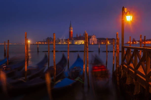 Early Morning view From St. Mark's Square in Venice Dawn breaks over the gondolas of Venice with the island of San Giorgio in the background venice italy grand canal honeymoon gondola stock pictures, royalty-free photos & images