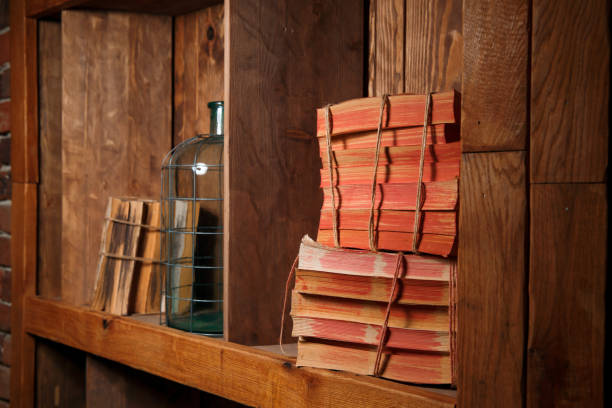 istock Old books, rewound with a rope, stand on a wooden shelf 1206771899