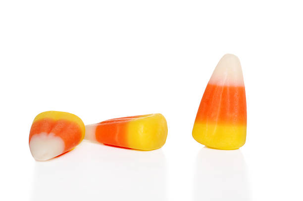 three candy corn isolated three candy corn candy corn stock pictures, royalty-free photos & images