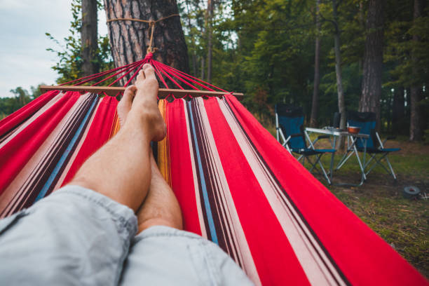istock man resting on hammock in forest summer time 1206773147