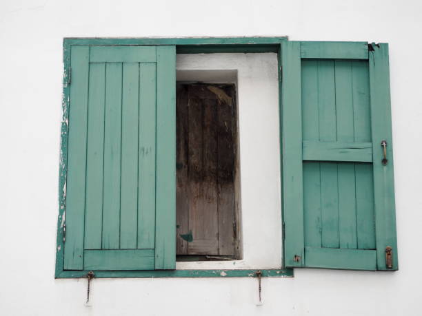 Open green wood old window on white wall, Retro house