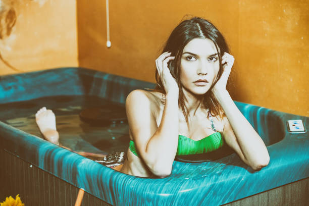 istock Beautiful woman relaxing in small pool 1206774324