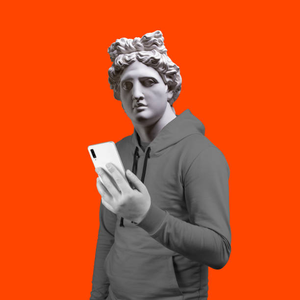 istock Modern art collage. Concept portrait of a man  holding mobile smartphone using app texting sms message. Gypsum head of of Apollo. Man in suit. On a orange background. 1206775612