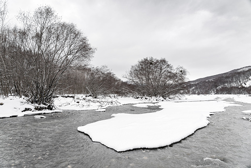 Mountain river in the winter season, covered with snow