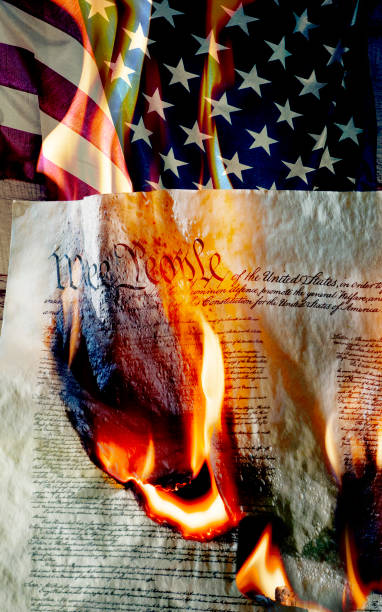 American constitution burning with flag in the background