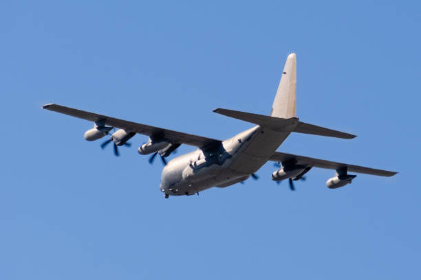 istock Back view of mid flight military transport aircraft 1206779156
