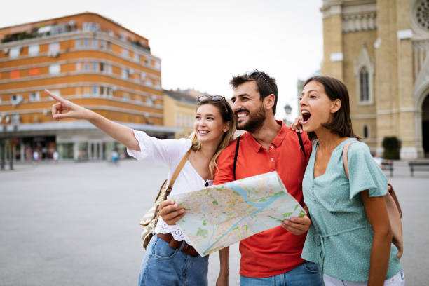 istock Happy traveling tourists sightseeing with map in hand 1206780764