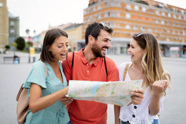 istock Happy traveling tourists sightseeing with map in hand 1206780771